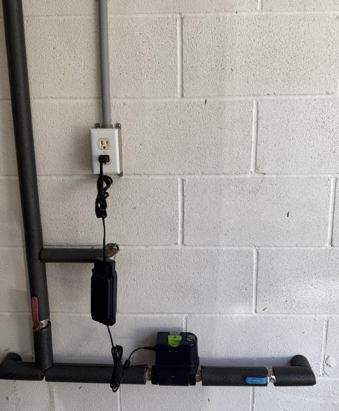 Smart home automatic water shutoff valve installed on main water line with insulated piping